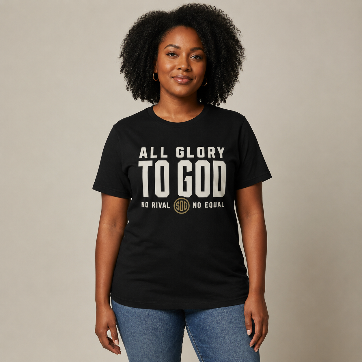 Woman wearing a black ALL GLORY TO GOD Softstyle Tee, shown from the front.